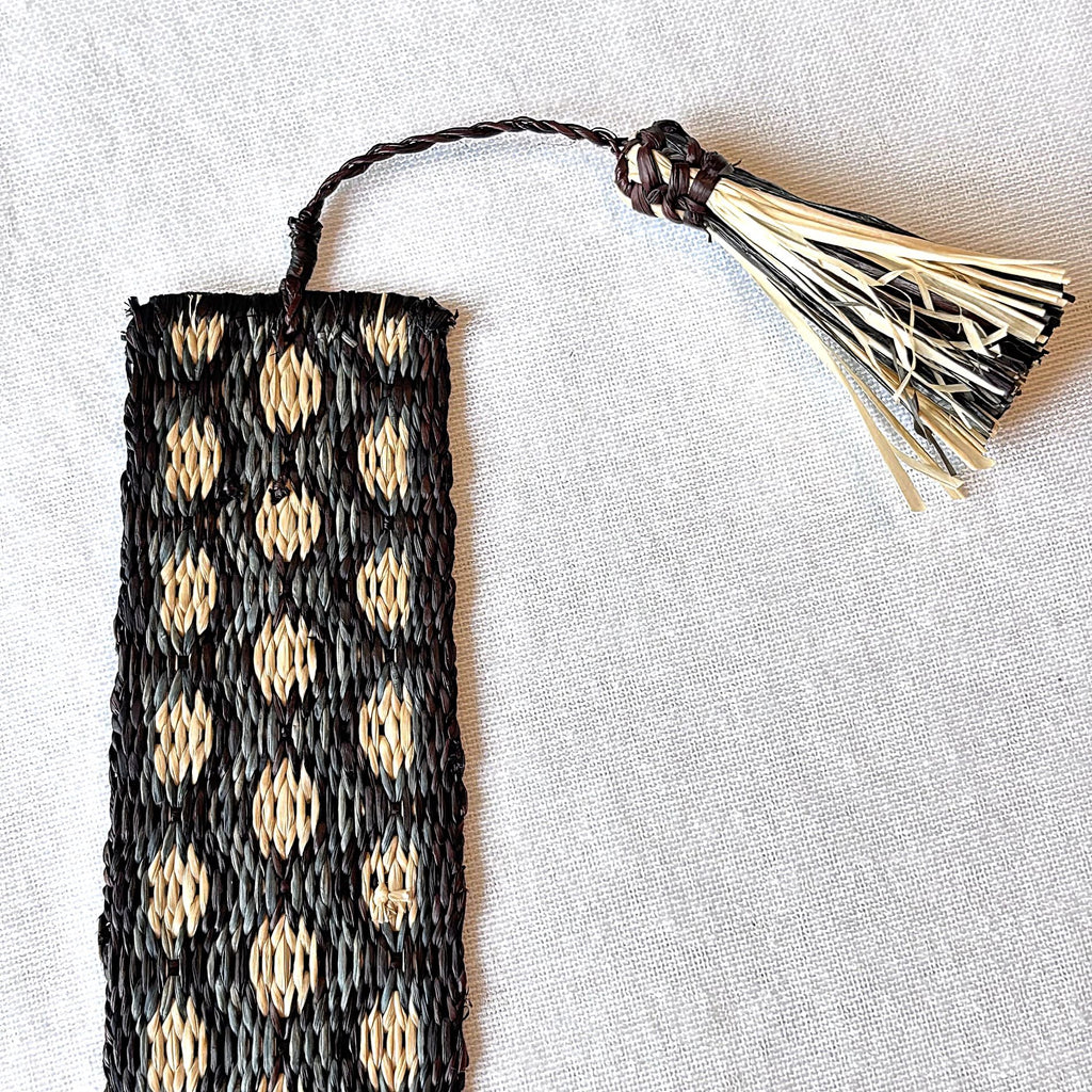 Handwoven raffia bookmark with pattern of charcoal, black, and light tan. Fair trade, handmade, sustainably sourced raw materials. Great gift for a man or woman.