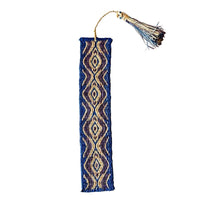 Handwoven raffia bookmark with pattern of blue, purple, and light tan. Fair trade, handmade, sustainably sourced raw materials.