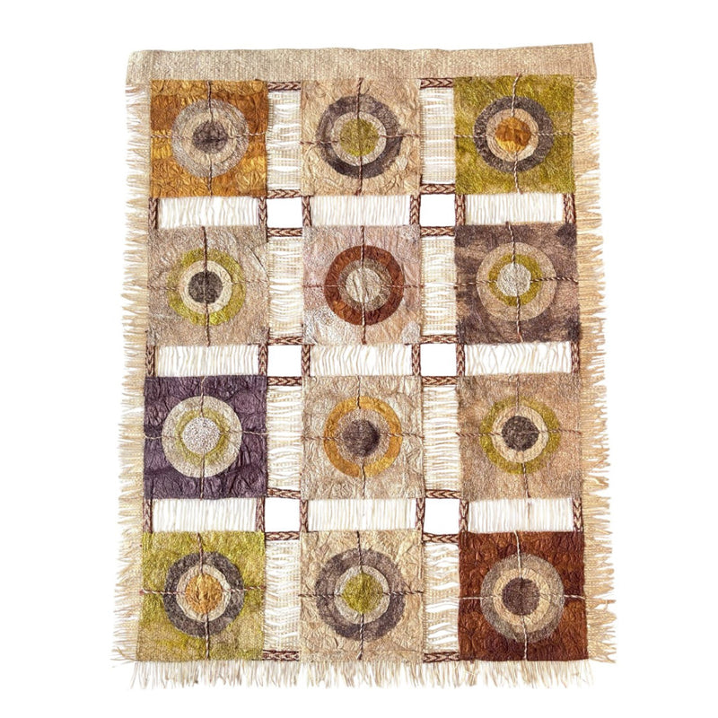 Wild silk textile wall hanging with geometric pattern and raffia tassels on edge. Nature-inspired, naturally dyed, fair trade, handmade.