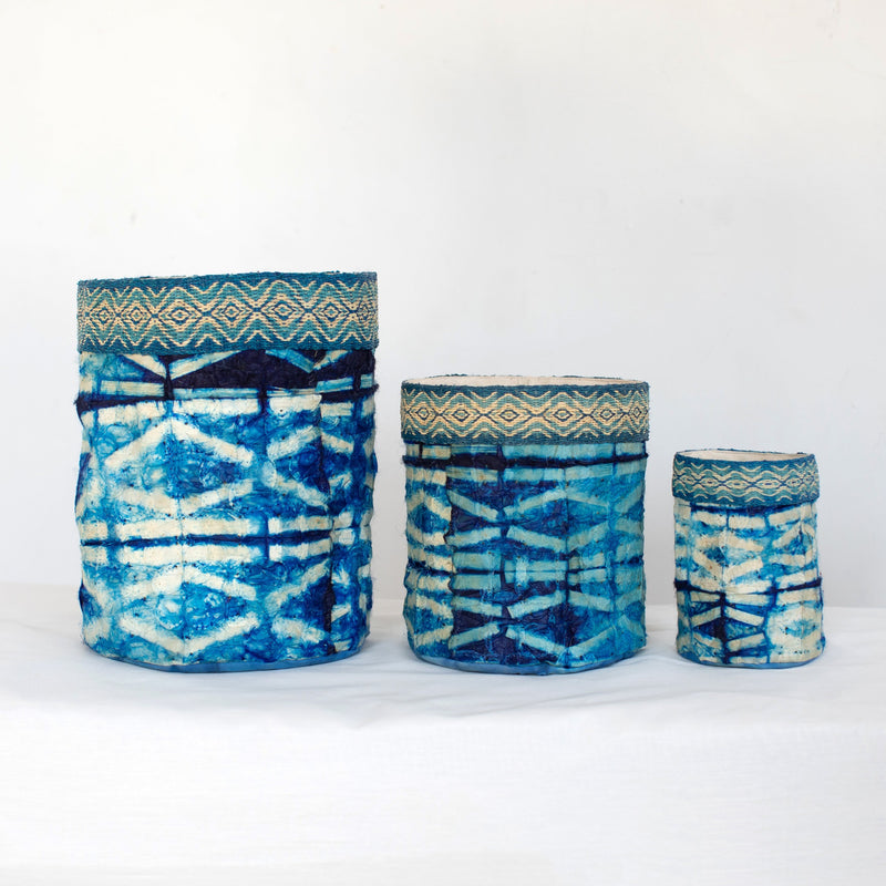 Handmade fair trade decorative basket indigo blue, sapphire blue, and white, shibori stick pattern, silk and raffia, made in Madagascar.