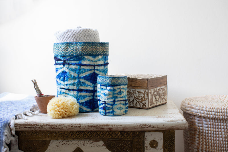 Handmade fair trade decorative basket indigo blue, sapphire blue, and white, shibori stick pattern, silk and raffia, made in Madagascar.